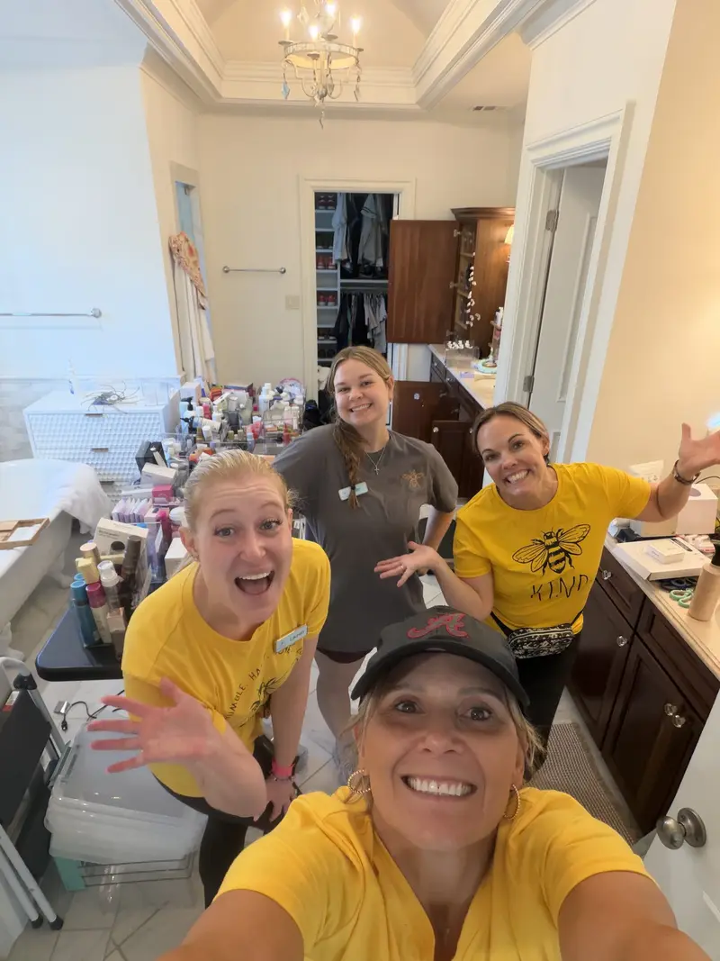 Simply Busy Bee organizers in yellow team shirts taking a selfie in a kitchen